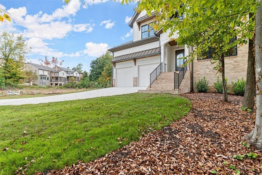 View of front of house featuring a garage and a front lawn