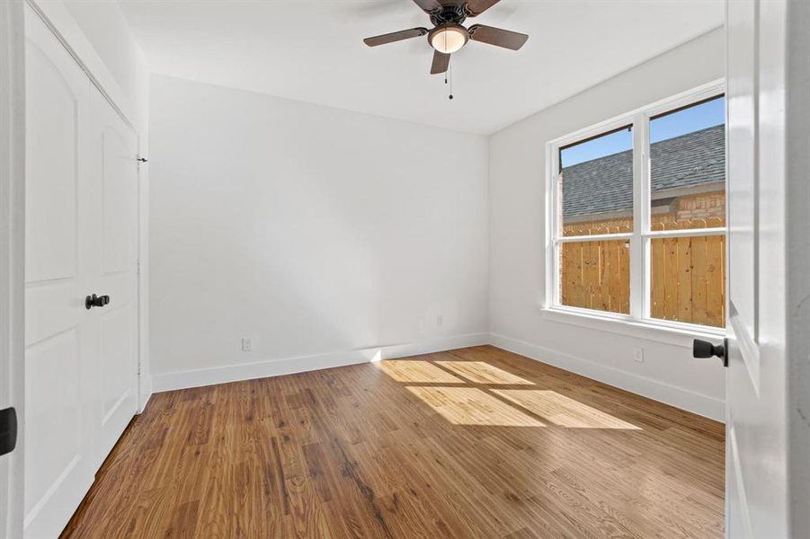 Unfurnished room with wood-type flooring and ceiling fan