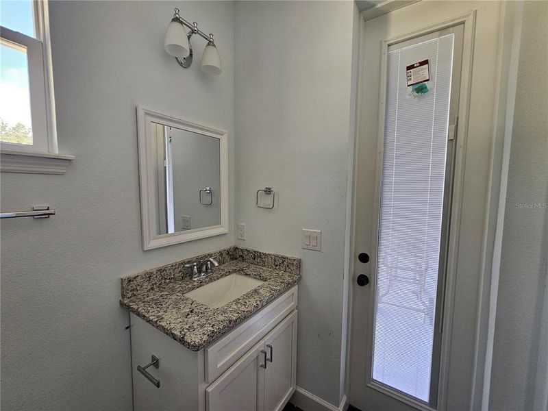 Guest Suite Bathroom Vanity with Exterior Door Exit with Internal Miniblinds