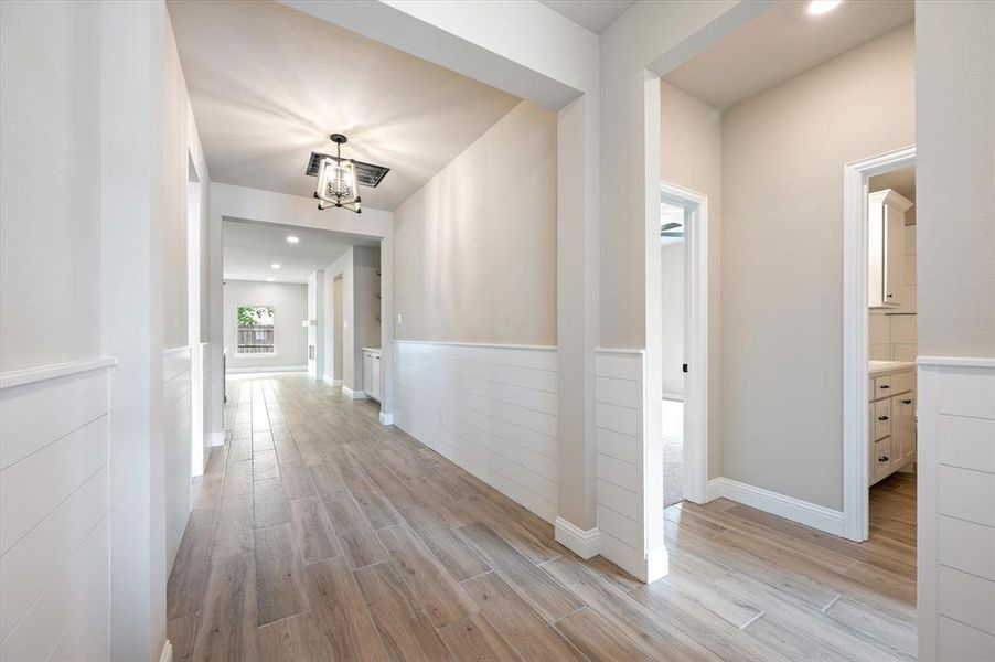 Hall with light hardwood / wood-style tile floors