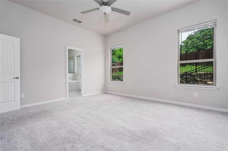 Carpeted spare room featuring ceiling fan