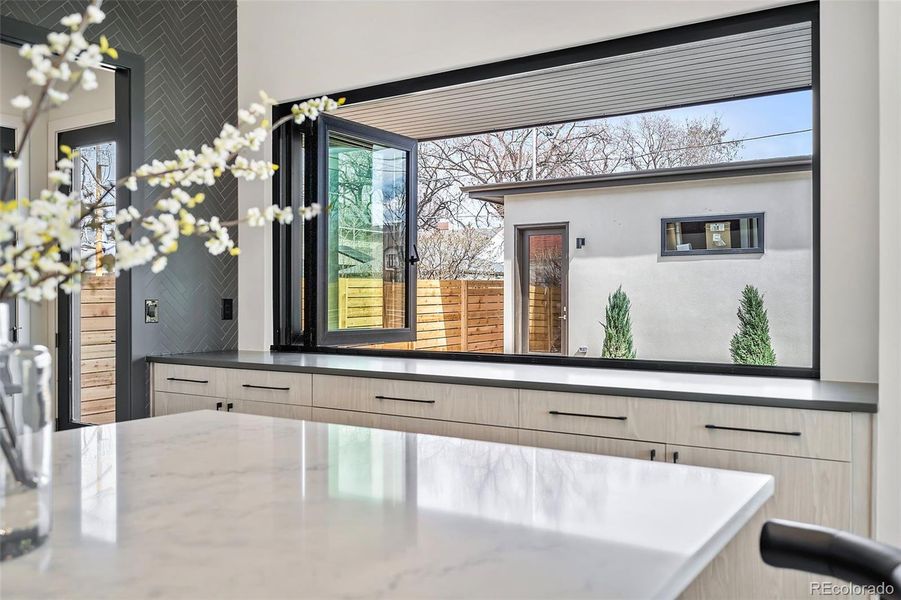 Seamless indoor-outdoor living with 15' of counters and cabinets.