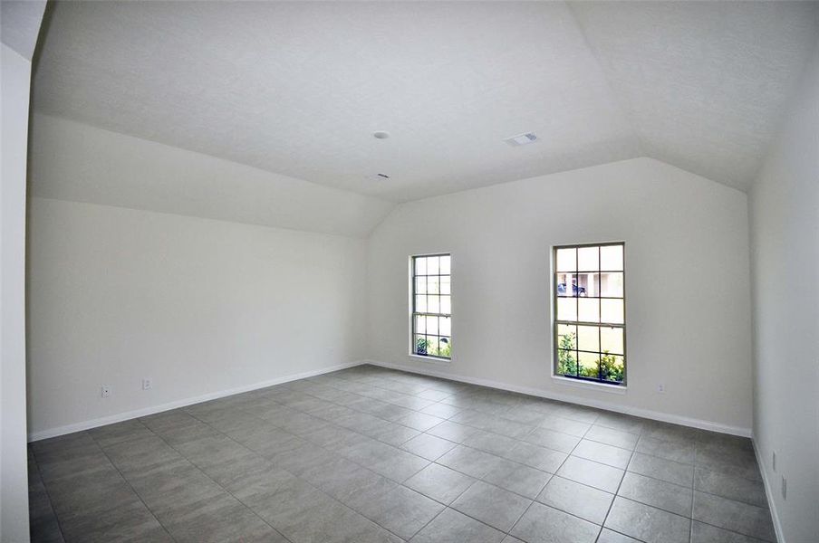 The master bedroom ceiling vaults to 10 ft. and the ceramic tile flooring continues.