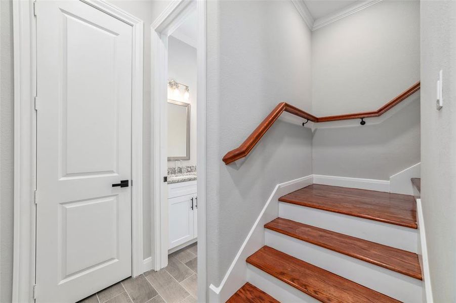 Ascend the grand wooden staircase to discover the home's four spacious bedrooms on the upper level.