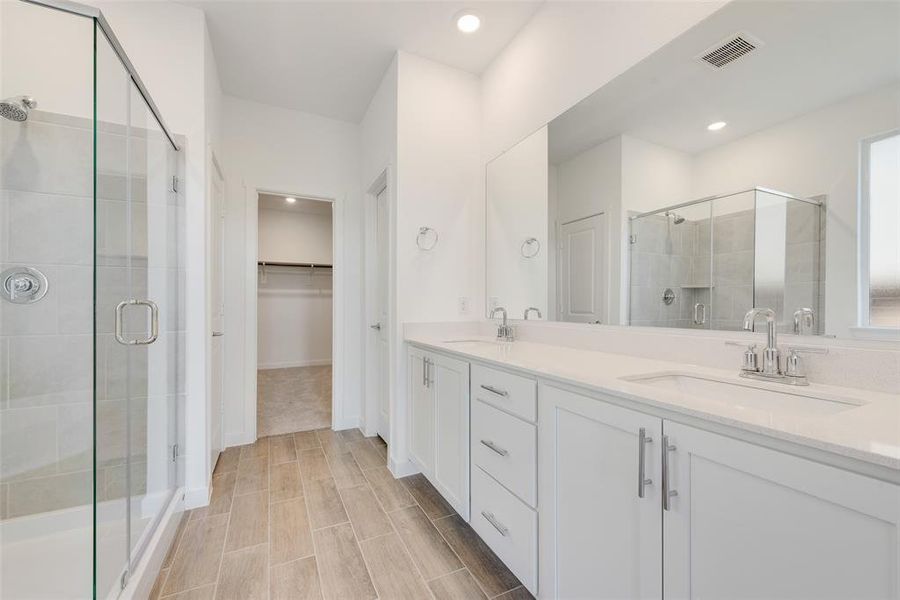 Bathroom with a shower with door and vanity