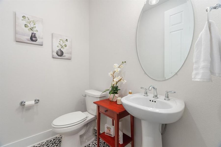 A half bath is located just off the entry hall ideal for guests.