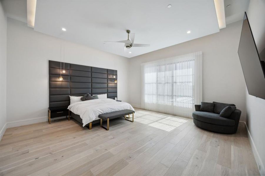 Bedroom with ceiling fan and light hardwood / wood-style floors