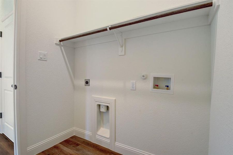 Laundry room featuring gas dryer hookup, dark hardwood / wood-style flooring, washer hookup, and hookup for an electric dryer