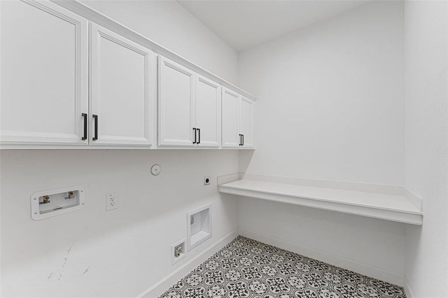 Say hello to this well-equipped laundry room, complete with sleek cabinets and a handy countertop—perfect for folding clothes and keeping everything organized.