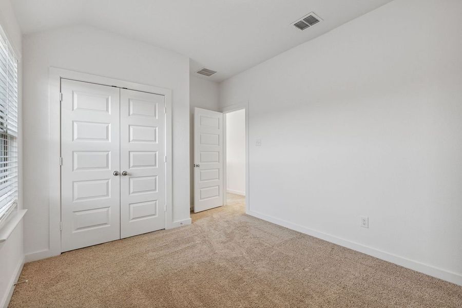 Bedroom in the Oak II home plan by Trophy Signature Homes – REPRESENTATIVE PHOTO