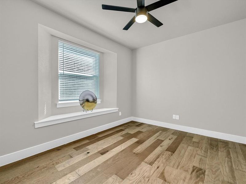 Unfurnished room with light wood-type flooring and ceiling fan