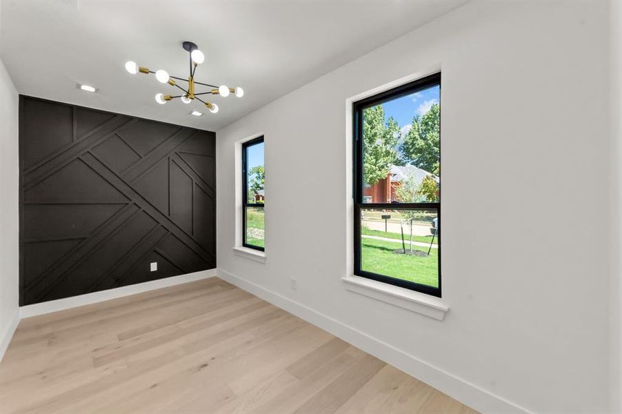 Office/Study room featuring light hardwood / wood-style floors and a notable chandelier