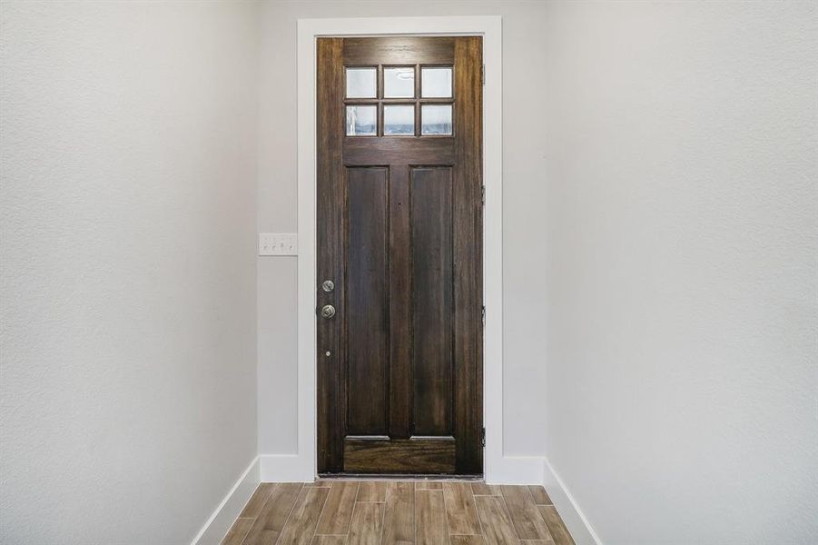 Doorway with light wood-type flooring