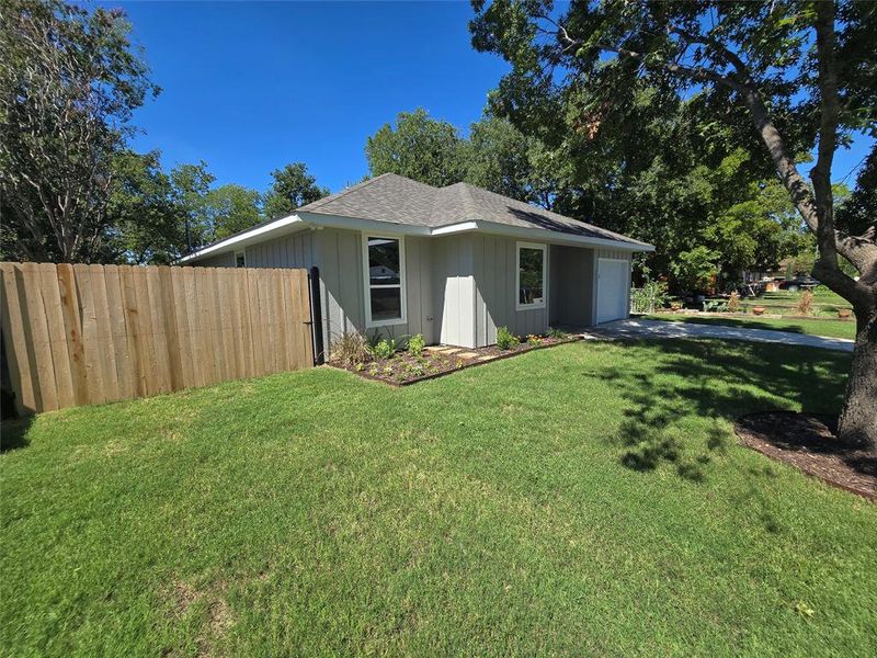 View of property exterior featuring a lawn