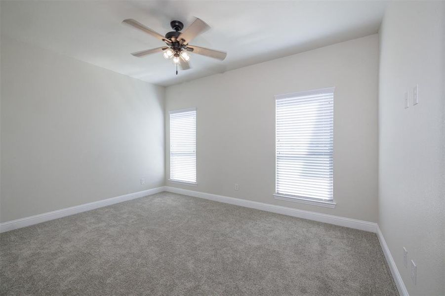 Empty room with carpet flooring and ceiling fan