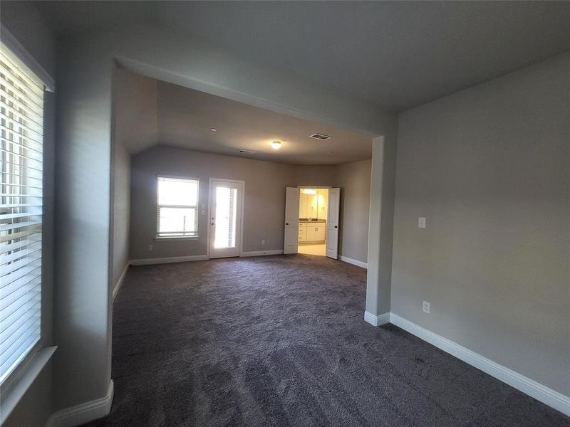 Unfurnished room featuring dark colored carpet