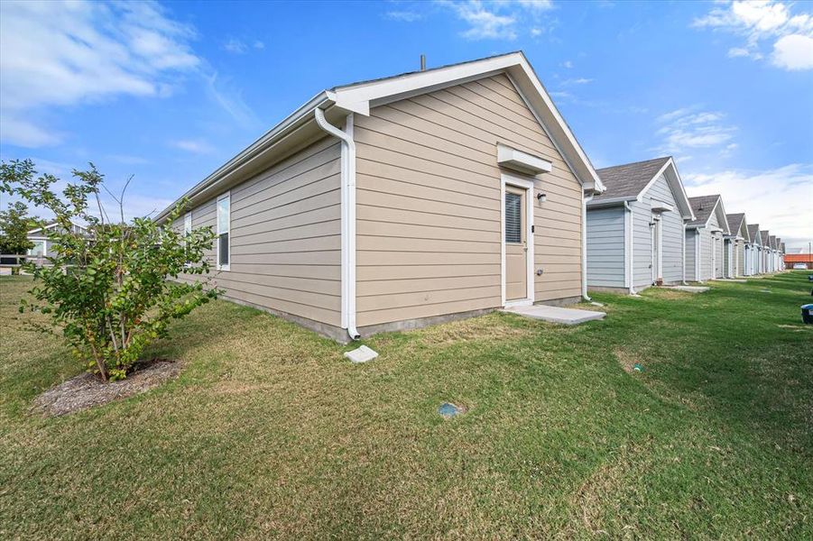 View of home's exterior with a yard