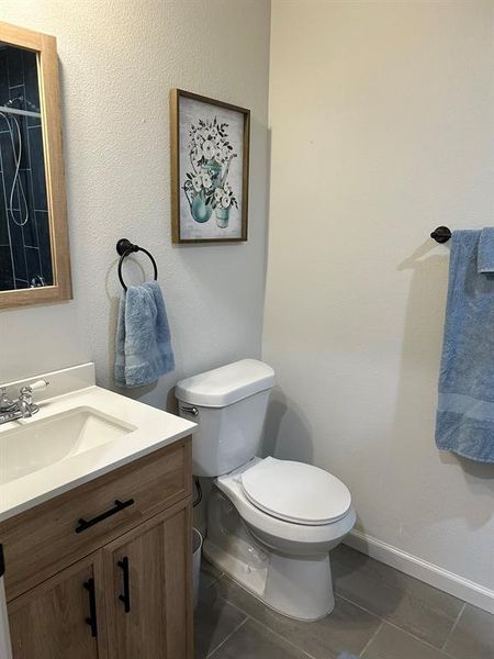 Bathroom featuring vanity, toilet, and tile patterned floors