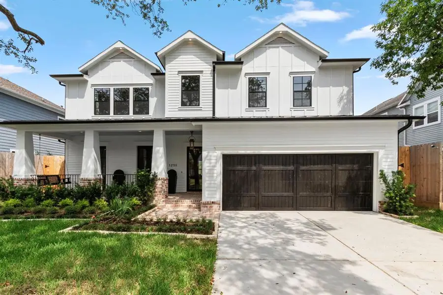 Home offers a 3-car tandem garage w/ extra wide brick patio & porch swing.