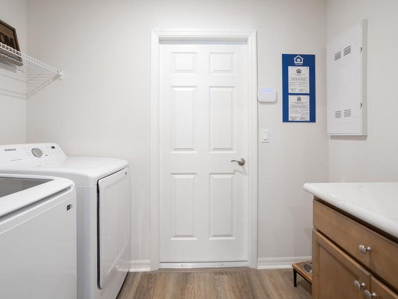 Laundry room with convenient drop zone, at the garage entry - Peyton home plan by Highland Homes
