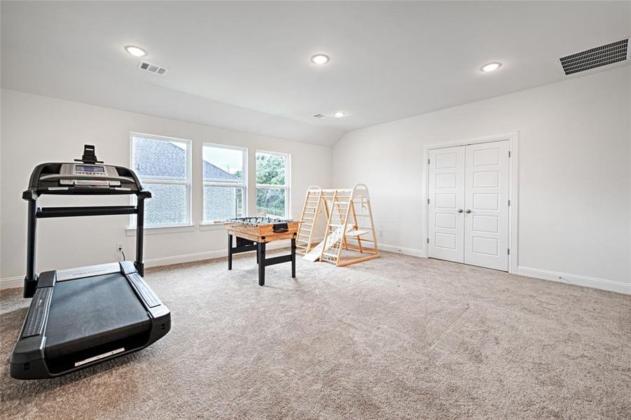 Workout area featuring light carpet