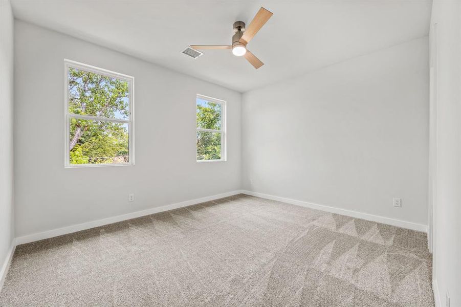 Spare room featuring carpet floors and ceiling fan