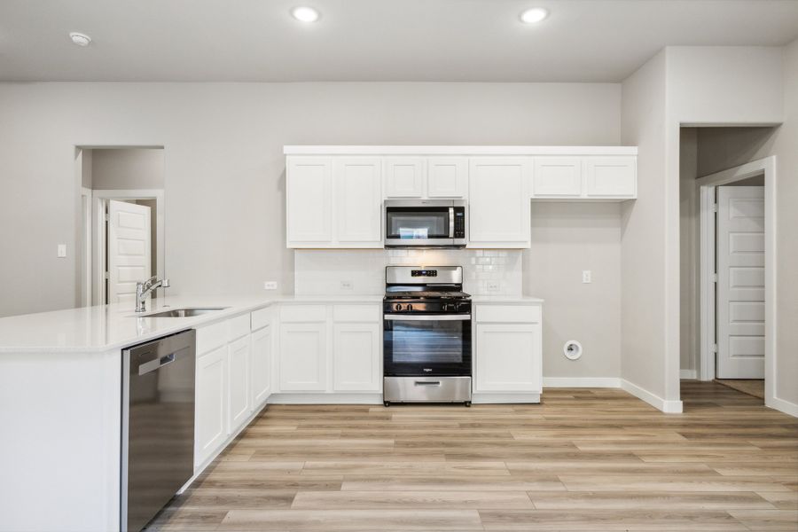 Kitchen in the Pecan home plan by Trophy Signature Homes – REPRESENTATIVE PHOTO