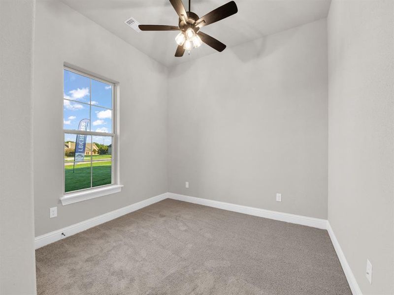 Spare room featuring carpet floors and ceiling fan