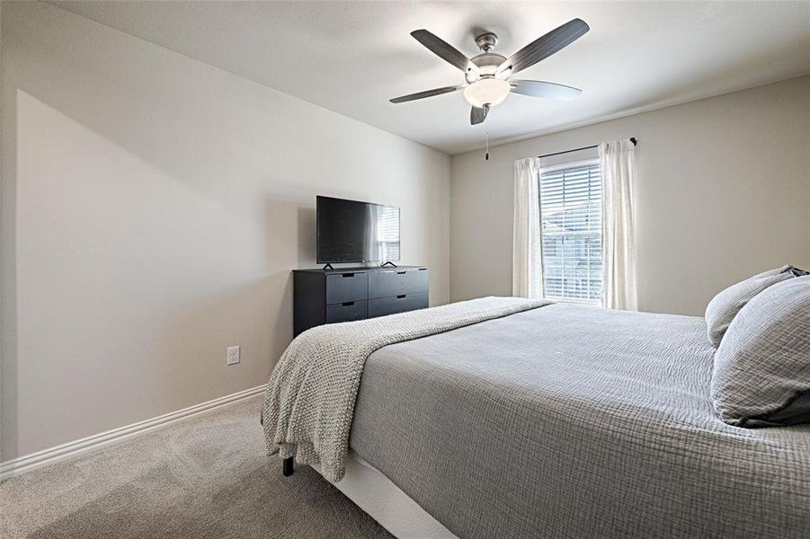 Bedroom 2 upstairs with fan, plush carpet and walk-in-closet