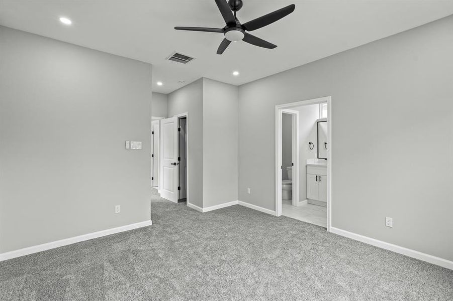 Upstairs room with plush carpet and ceiling fan!