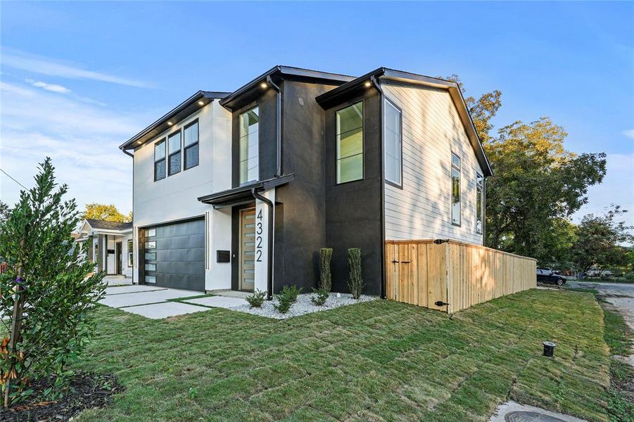 View of front of home featuring a garage and a front lawn