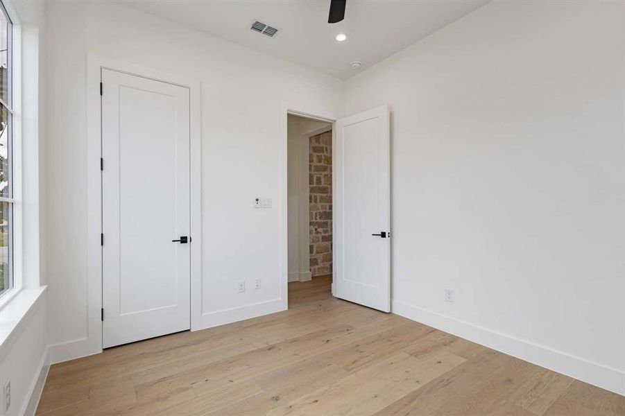 Unfurnished bedroom featuring light wood-type flooring and ceiling fan