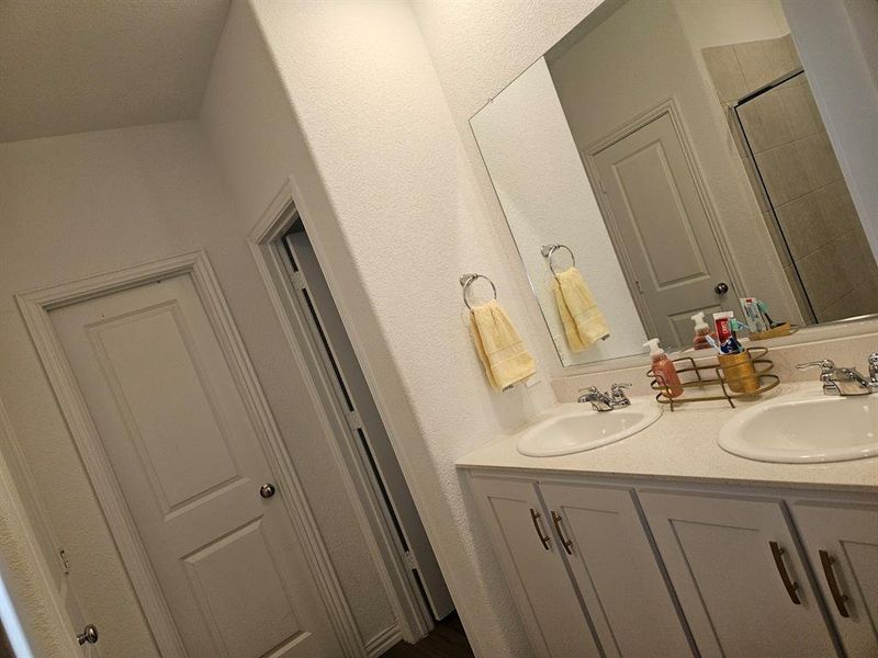 Bathroom featuring vanity and an enclosed shower