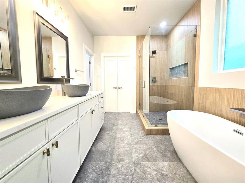 Bathroom featuring tile patterned flooring, plus walk in shower, and vanity
