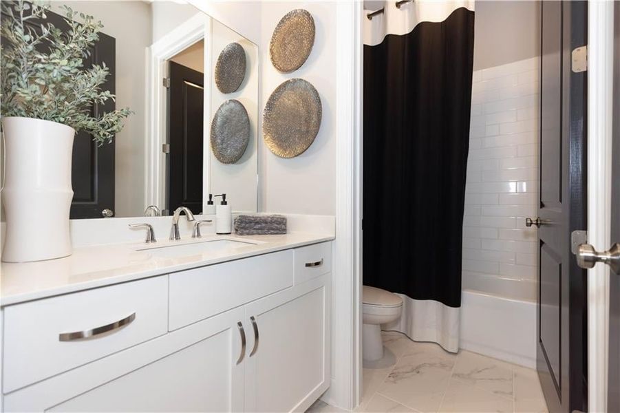 This delightful secondary bath will feature quartz counter tops and tiled shower!