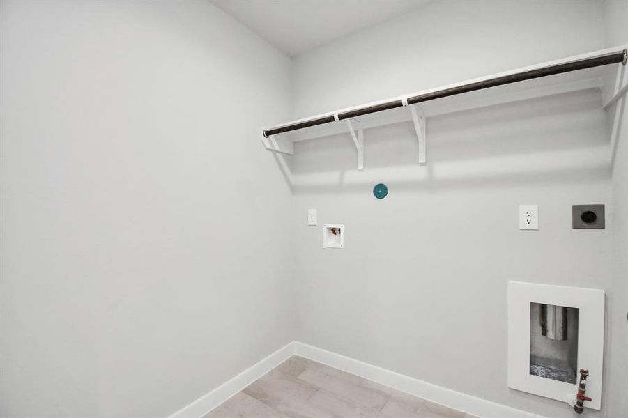 Located on first floor, a stylish laundry room where practicality meets a contemporary aesthetic. The dark finishes lend a sophisticated touch, creating a space that is both functional and visually appealing. Both electric and gas connections available.