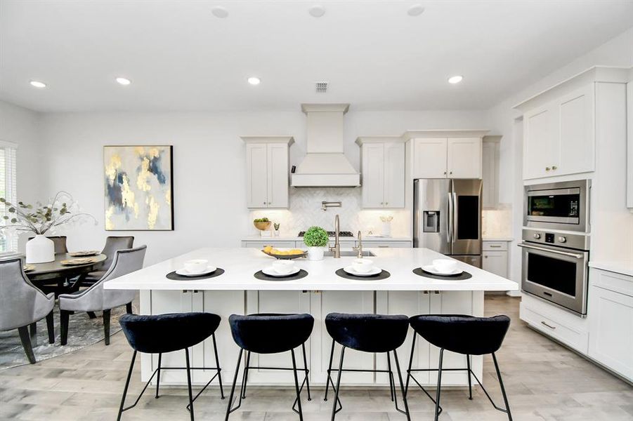 Step into this modern kitchen withlight cabinets, beautiful chevron tiletying in the tile at the entry of thehome, stainless steel appliances,upgraded large sink and plenty ofstorage from the uppers and lowersas well as storage in the island.