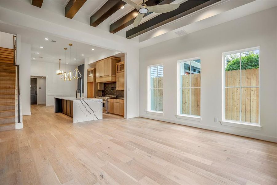 Elevated ceiling fan in this space. Three large windows provide ample natural light.