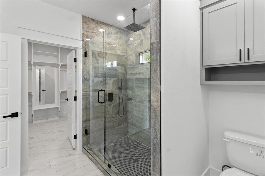 Bathroom featuring toilet and walk in shower