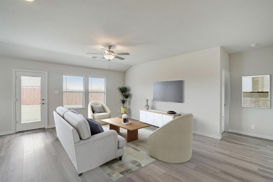 Virtually staged-Living area with light hardwood / wood-style floors and ceiling fan