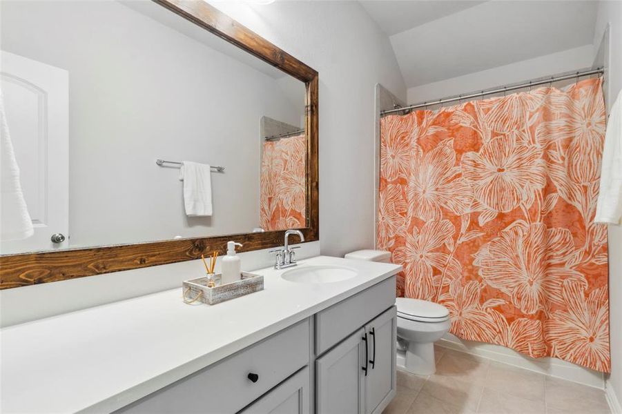 Upstairs Bathroom with quartz countertops, rustic custom mirror and extra under counter storage.