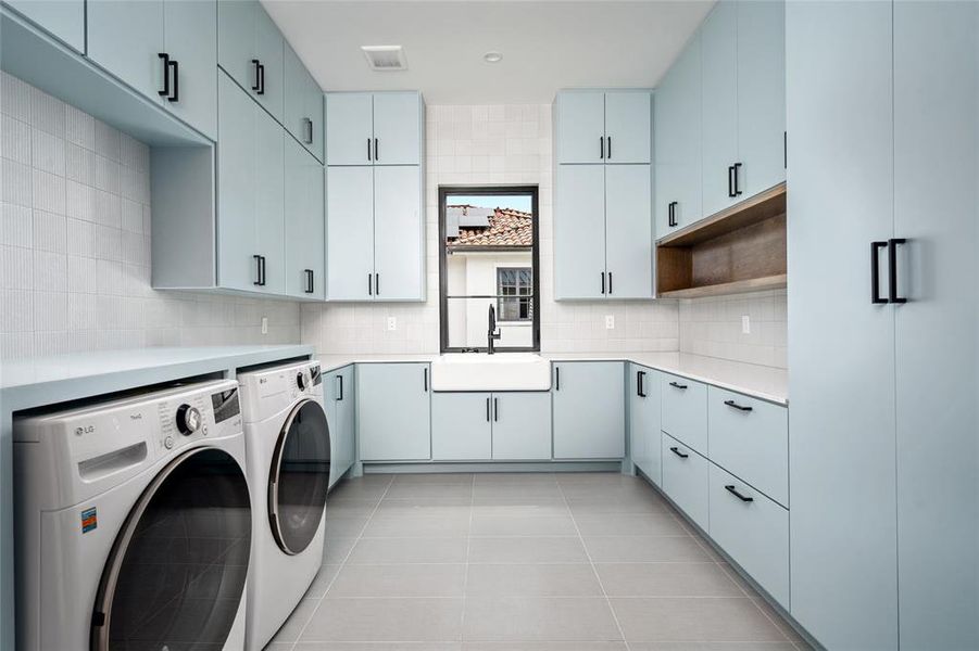 The oversized laundry room is a standout feature, boasting a large sink and floor-to-ceiling bespoke cabinetry, it provides ample storage and functionality for all your laundry needs.