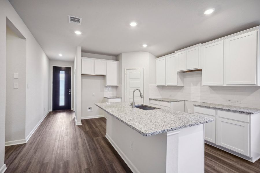 Entry and kitchen in the Allen floorplan at a Meritage Homes community.