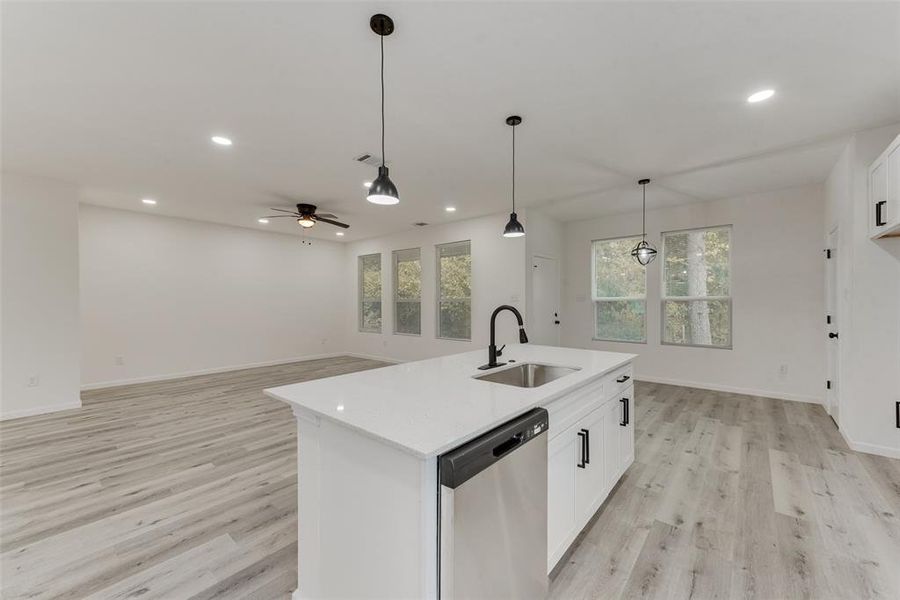 Kitchen with dishwasher, sink, an island with sink, white cabinets, and ceiling fan