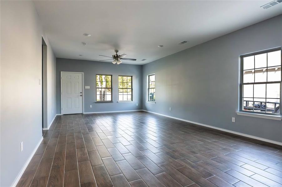 Unfurnished room featuring ceiling fan and dark hardwood / wood-style floors