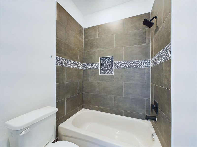 Secondary bathroom with tub/shower combo. Model home photos