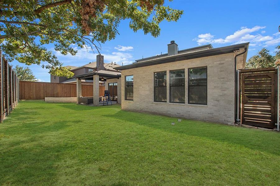 Rear view of property with a yard and a patio