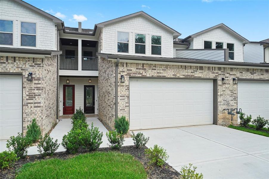 New construction townhome in the gated community of Point Aquarius. Nice landscaping welcomes you to the entry with overhead second floor balcony.