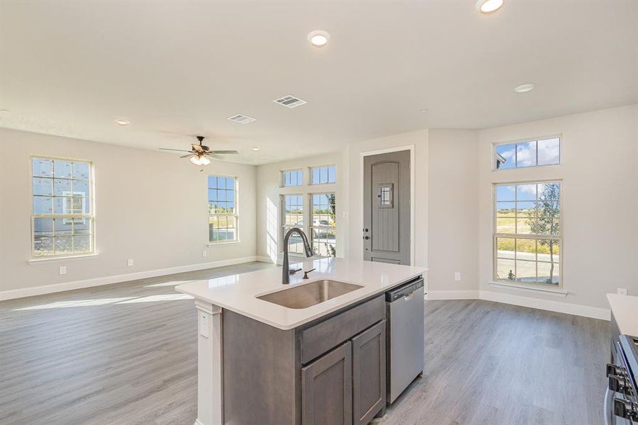 Kitchen featuring light hardwood / wood-style flooring, dishwasher, a healthy amount of sunlight, and sink