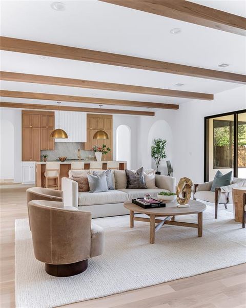 Living room featuring beamed ceiling and light hardwood / wood-style flooring